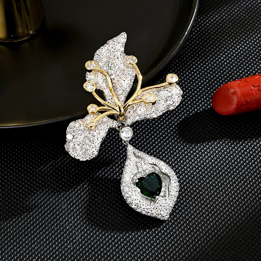 Elegant Silver and Gold Leaf Brooch with Green Gem